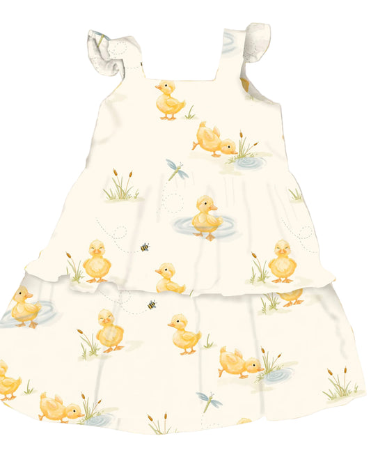 Baby dress with duck pattern on a white background