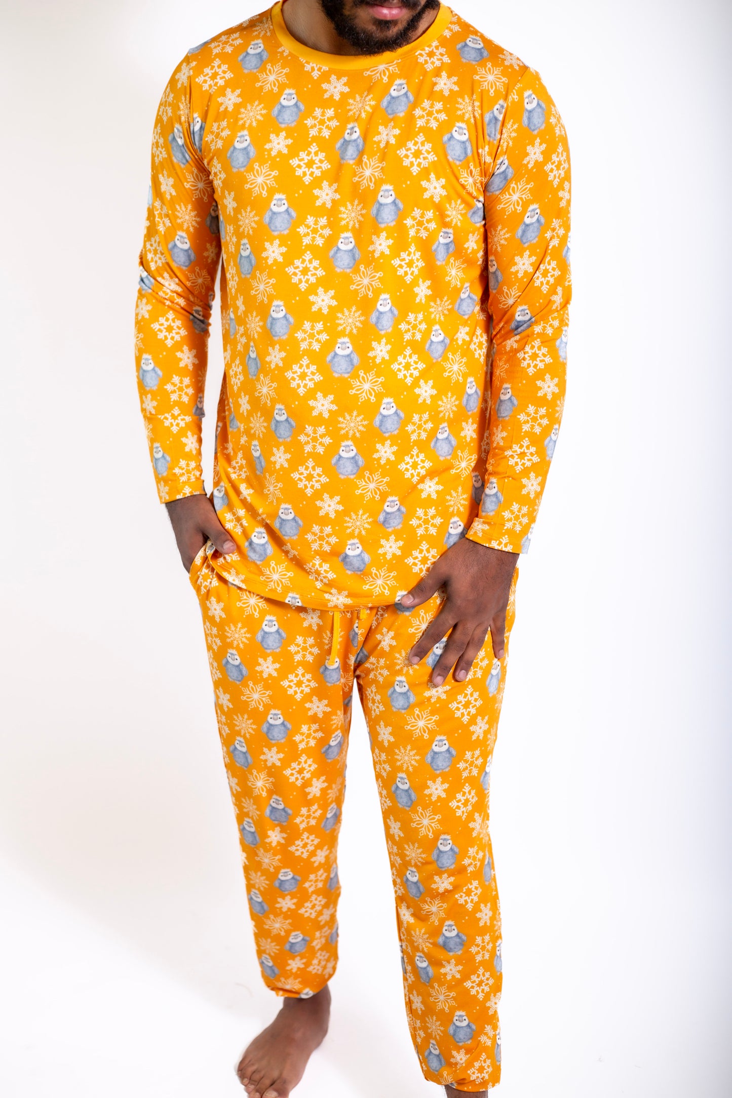 Person wearing a bright orange pajama set with a pattern of small blue characters on a white background