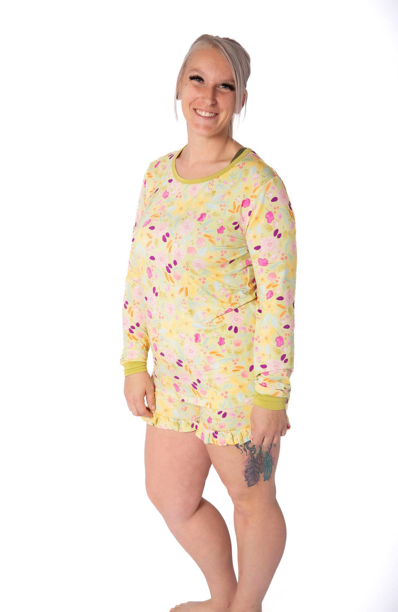 Woman wearing a yellow patterned nightshirt on a white background