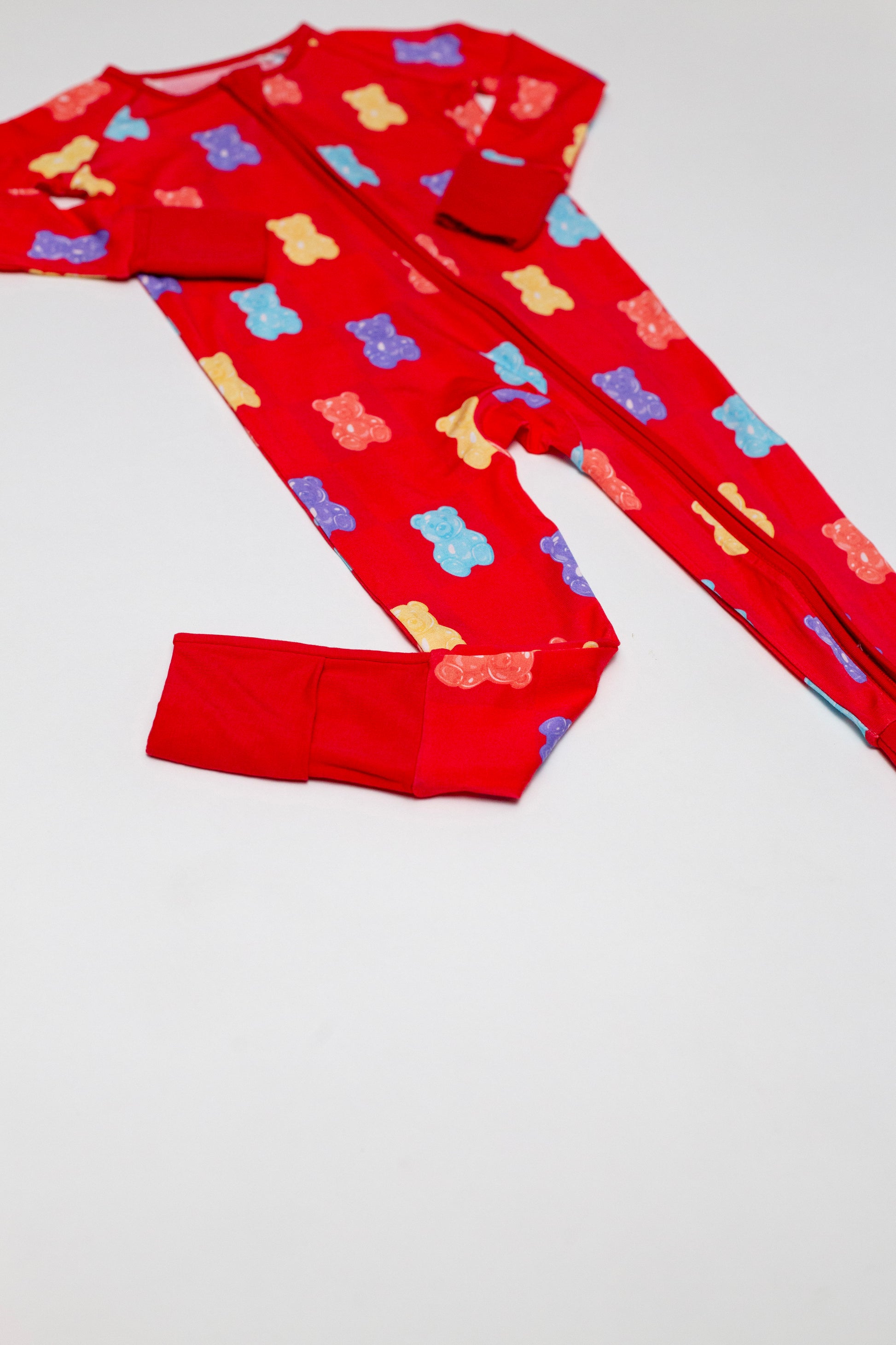 Red pajama set with colorful bear pattern on a white background