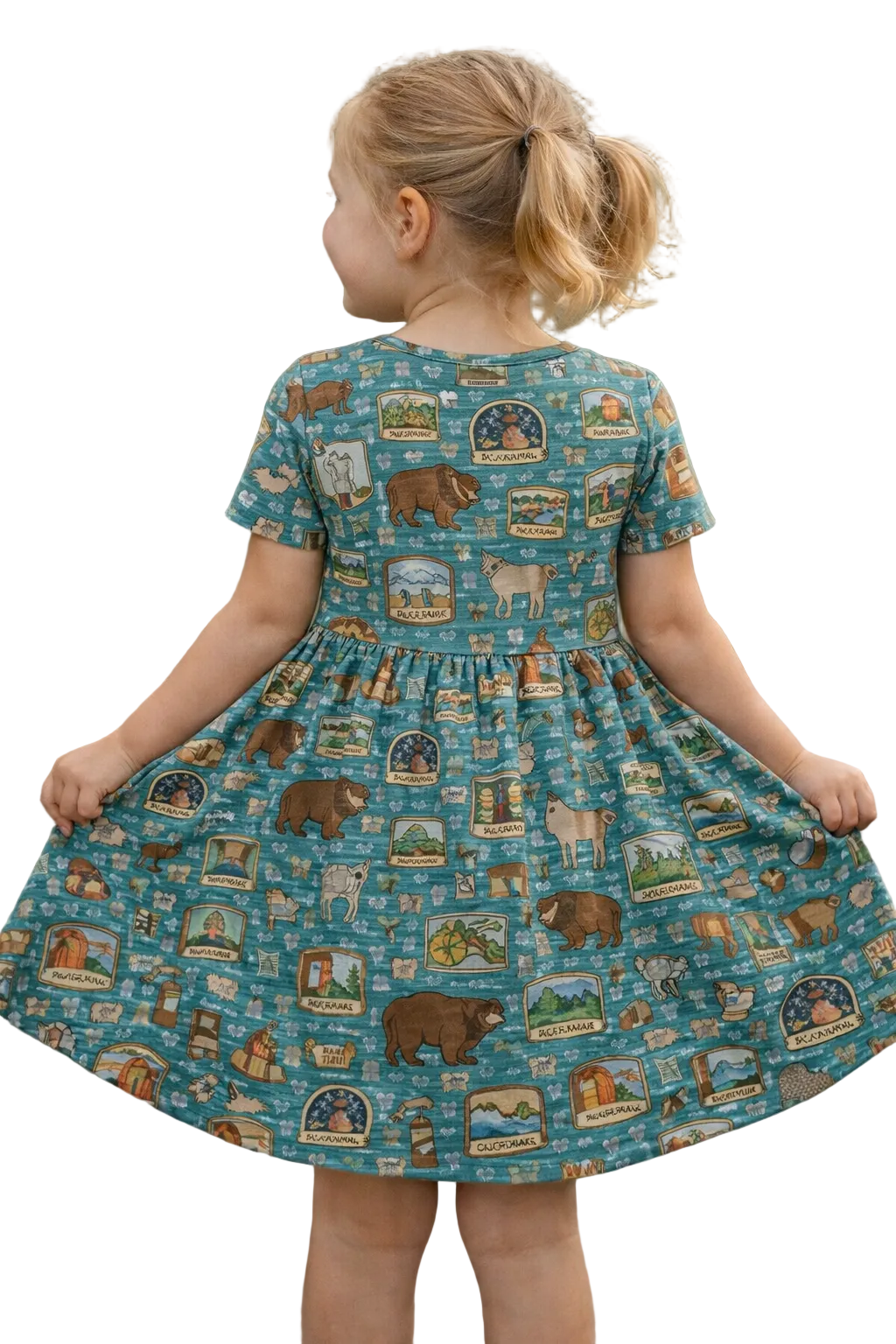 Child wearing a dress with a nature-themed pattern against a blurred natural background