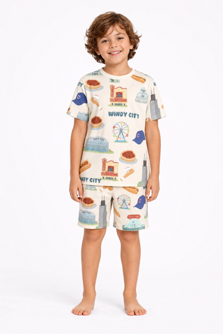 Child wearing a pajama set with a 'Windy City' theme on a white background