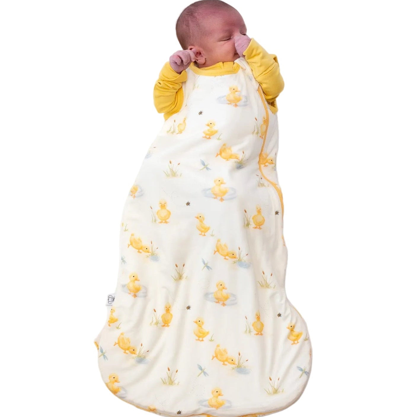 Newborn baby wrapped in a duck print bamboo sleep sack that is buttery soft.