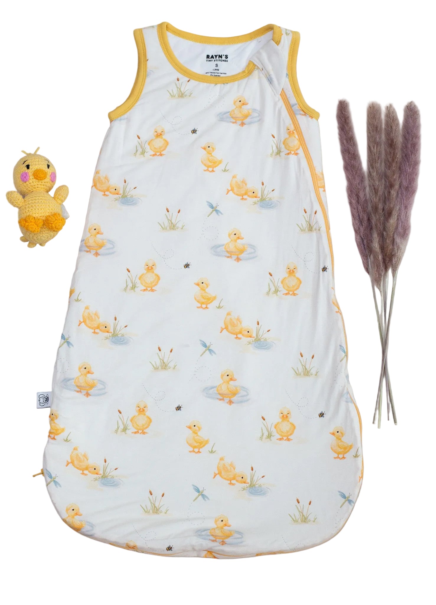 Baby sleeping bag with duck pattern on a beige background