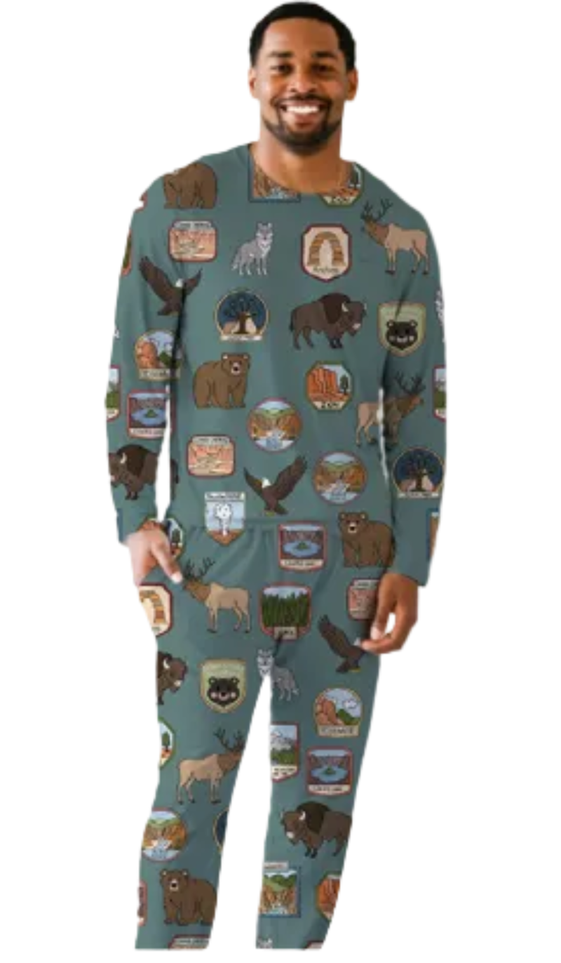 Man wearing a patterned onesie with nature-themed designs on a white background