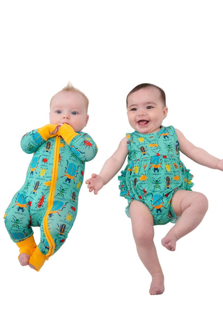 Two babies wearing colorful outfits on a white background