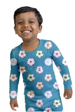 Child wearing a blue pajama set with colorful patterns on a white background