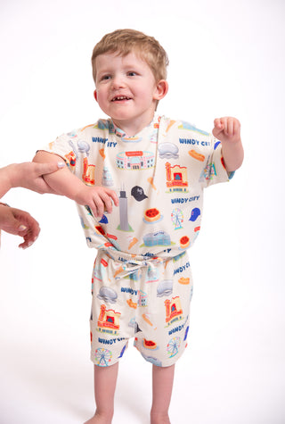 Toddler wearing My First Windy City bamboo pajamas featuring Chicago skyline, Navy Pier, deep dish pizza, and Windy City inspired artwork