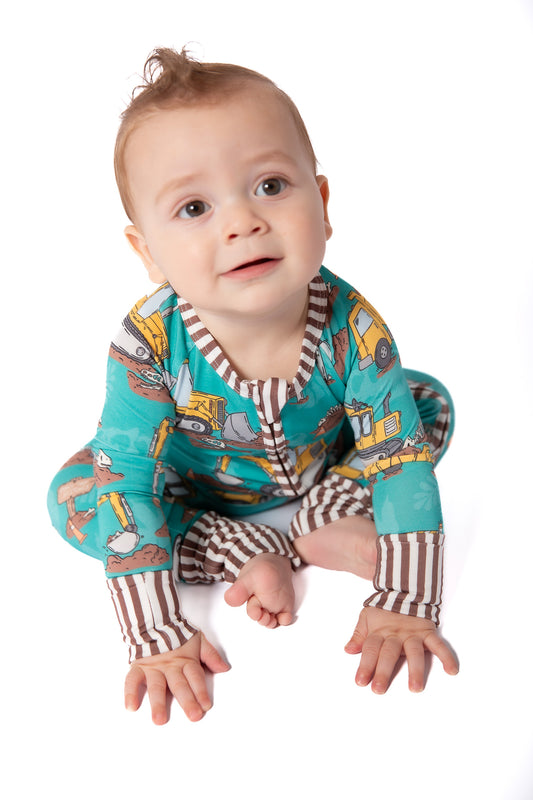 Baby wearing a colorful onesie with long-sleeve protection on a white background