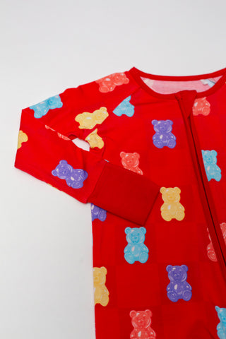 Red children's onesie with colorful bear pattern on a white background