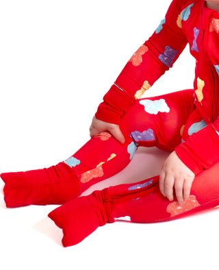 Red children's outfit with colorful cloud patterns on a white background