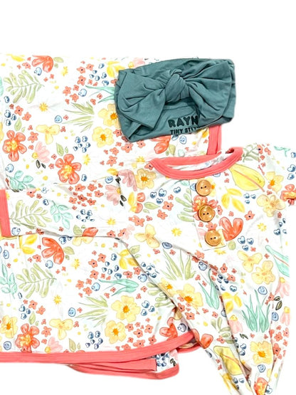 Floral-patterned bag with a green headband on a white background