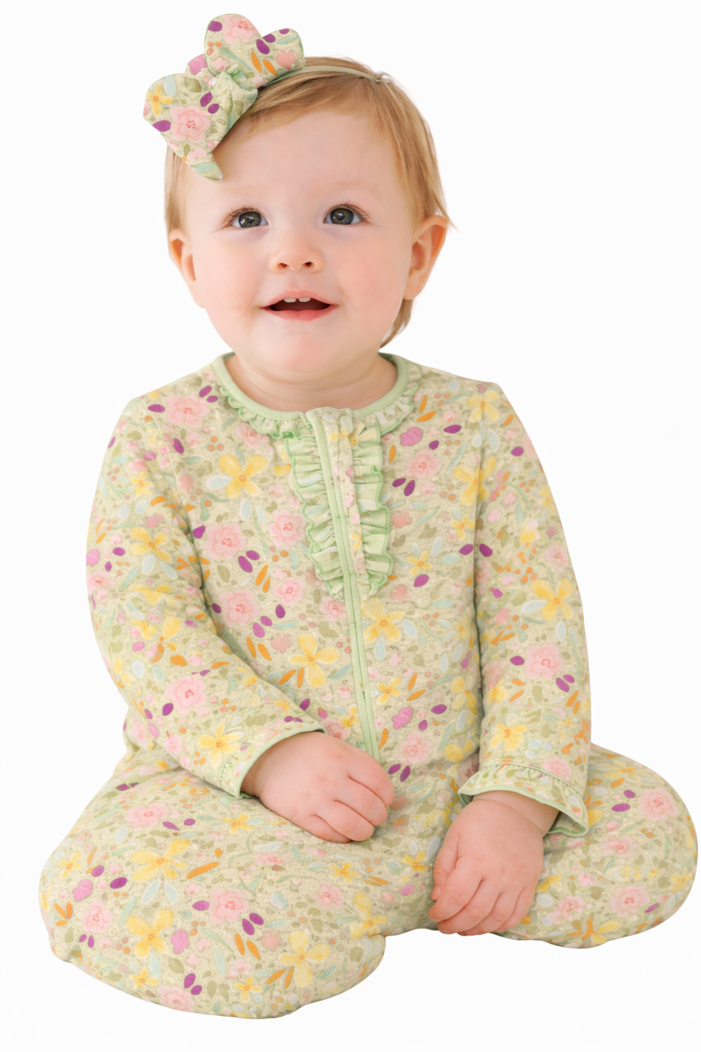 Baby in a floral onesie with a white background