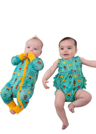 Two babies wearing colorful outfits on a white background