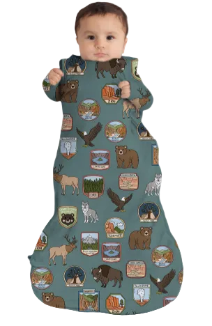 Baby in a sleeping bag with nature-themed design
