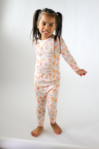 Child wearing a floral onesie on a white background