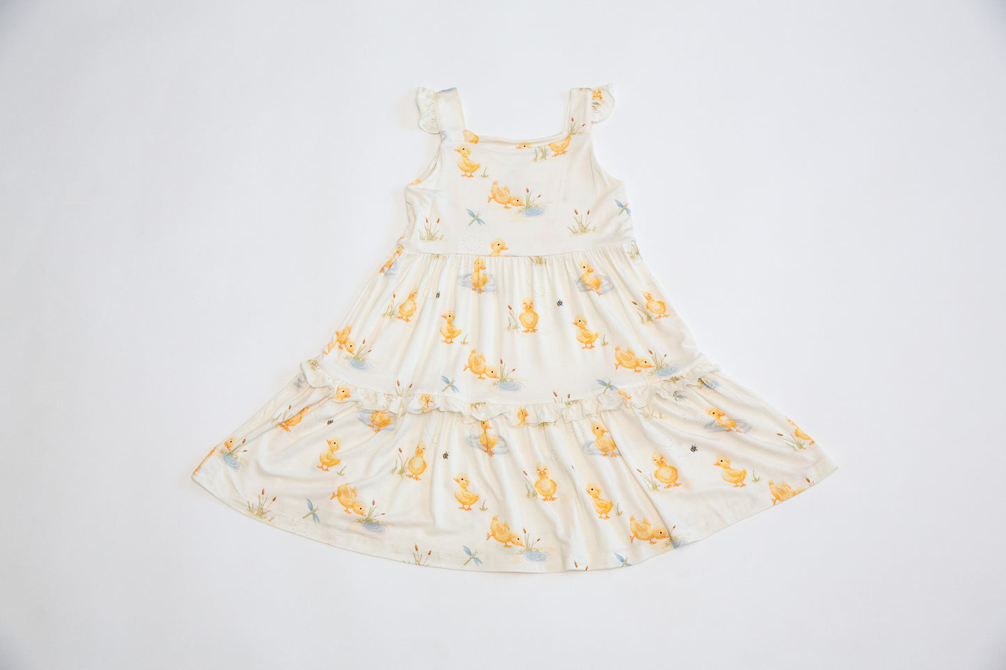 White dress with yellow floral pattern on a white background