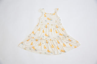 White dress with yellow floral pattern on a white background