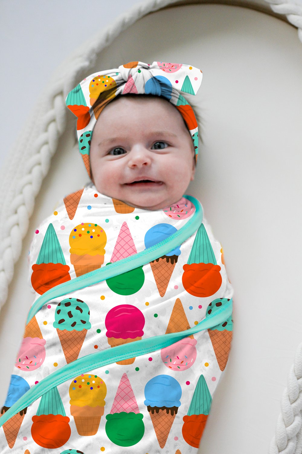 Baby wearing a colorful ice cream patterned outfit and headband.