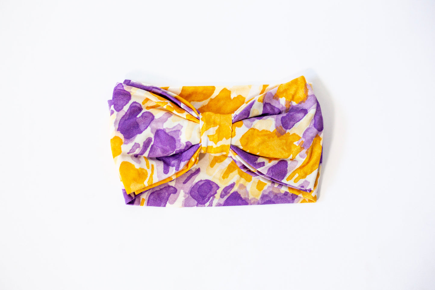 Floral-patterned headband with a bow on a white background