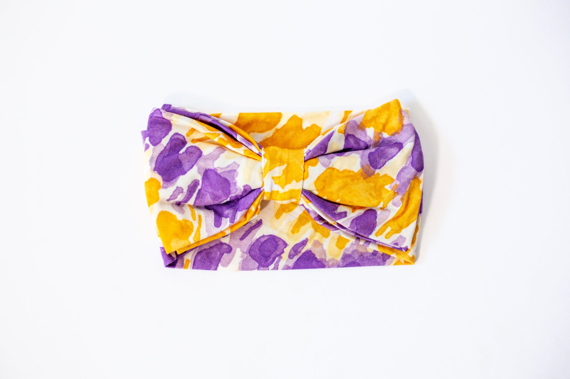 Floral-patterned headband with a bow on a white background