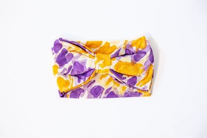 Floral-patterned headband with a bow on a white background