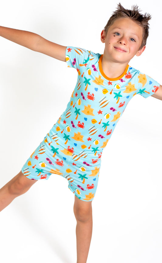 Child wearing a colorful pajama set with a white background