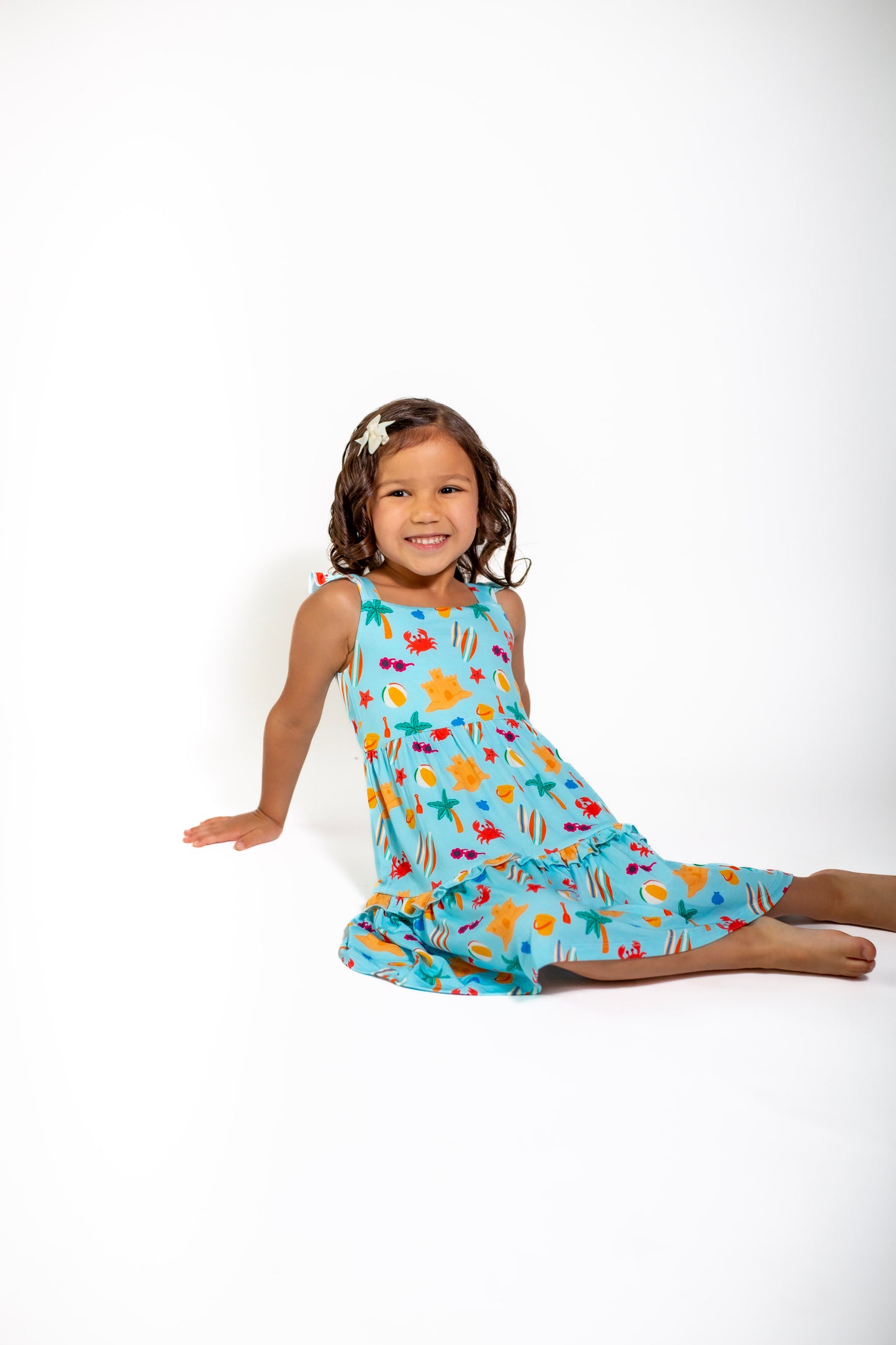 Young girl wearing a colorful dress with a white background