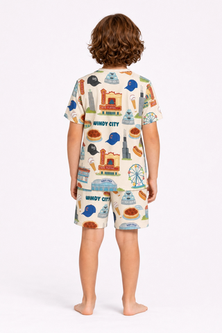 Kids wearing Windy City Chicago bamboo pajama set with oversized shirt and drawstring shorts featuring Chicago skyline, Navy Pier, and deep dish pizza artwork