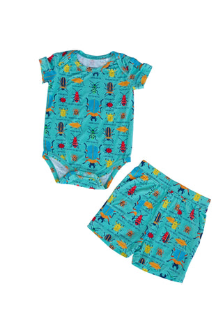 Children's outfit with short-sleeve romper and shorts featuring a colorful pattern on a light blue background.