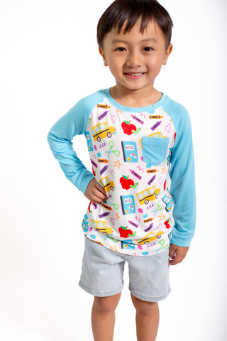 Child wearing a long-sleeve shirt with a colorful pattern on a white background