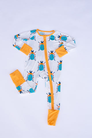 Baby onesie with beetle pattern and orange accents on a light gray background