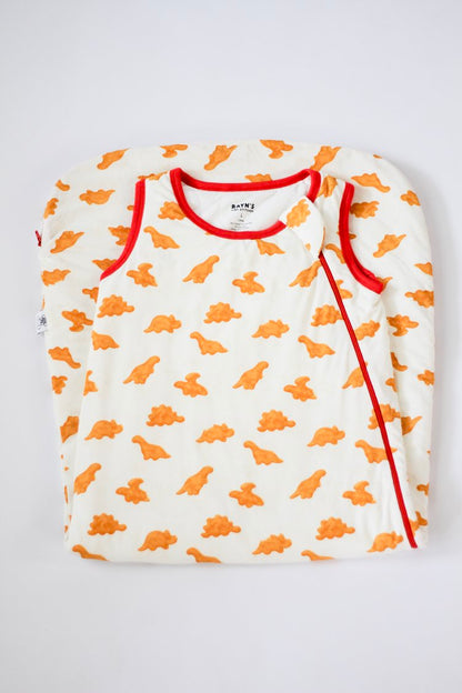 Children's long-sleeve shirt with orange dinosaur pattern on a white background