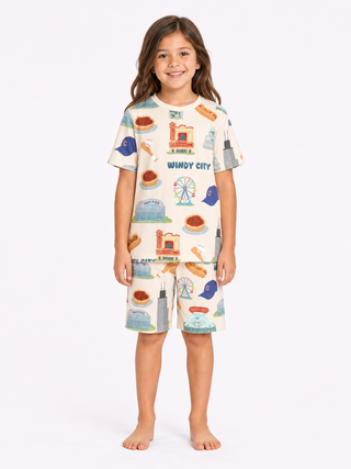 Kids wearing Windy City Chicago bamboo pajama set with oversized shirt and drawstring shorts featuring Chicago skyline, Navy Pier, and deep dish pizza artwork