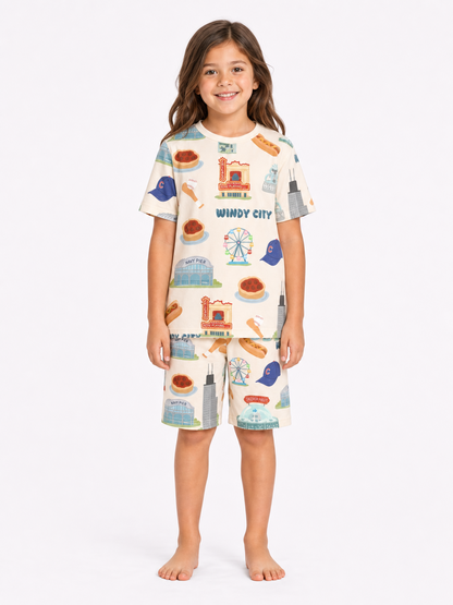 Kids wearing Windy City Chicago bamboo pajama set with oversized shirt and drawstring shorts featuring Chicago skyline, Navy Pier, and deep dish pizza artwork