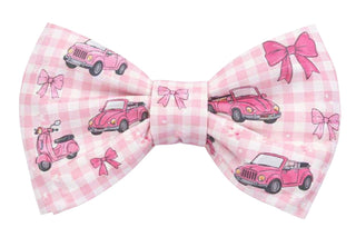 Pink checkered bow tie with vintage car and scooter designs on a white background