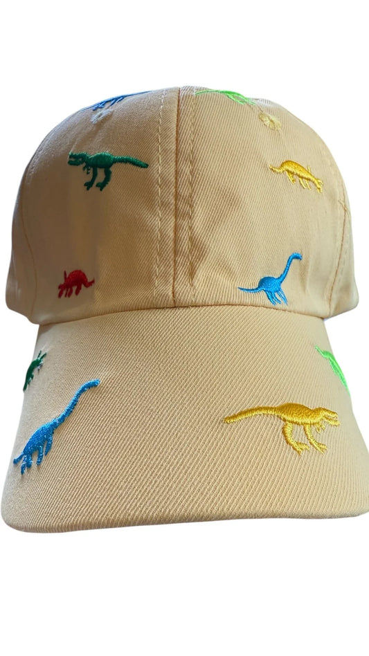 Beige cap with embroidered colorful dinosaur designs on a white background