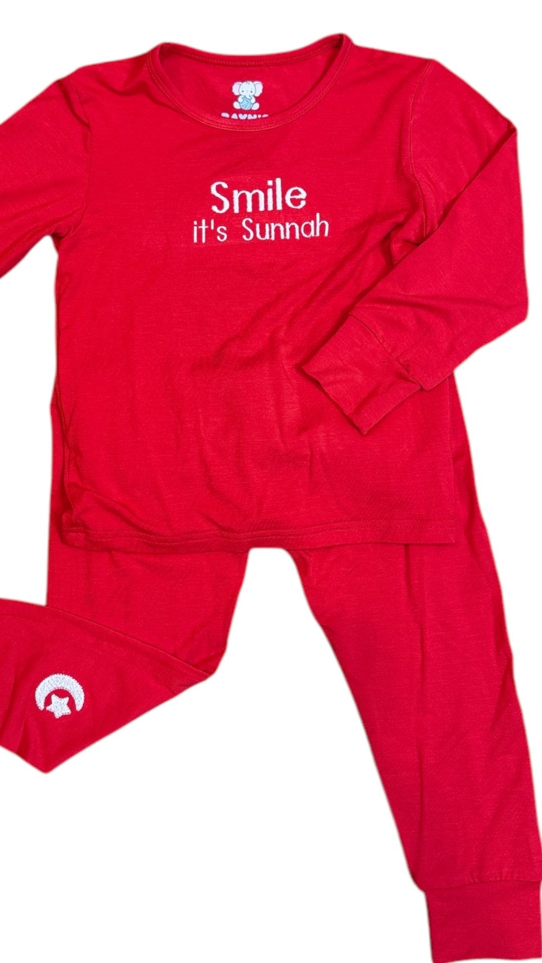 Red children's pajama set with 'Smile it's Sunnah' text on a white background