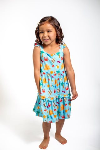 Young girl wearing a colorful dress with a white background