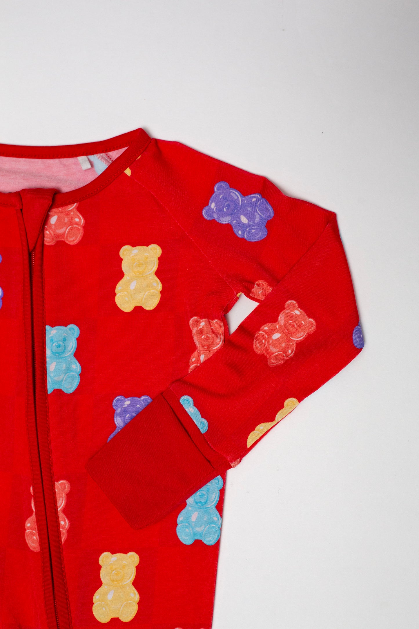 Red children's outfit with teddy bear pattern on a white background