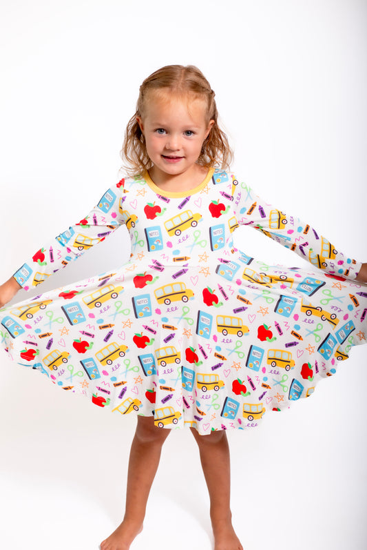 Young girl wearing a dress with colorful patterns on a white background
