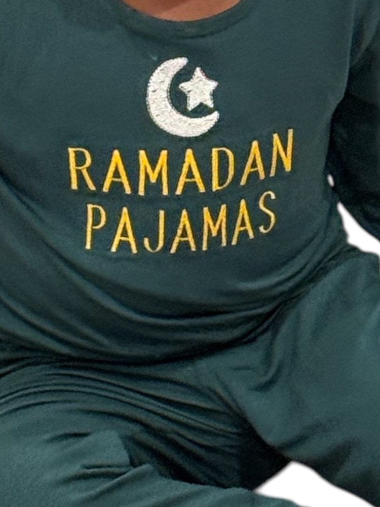 Green pajama set with 'Ramadan Pajamas' text and crescent moon design.