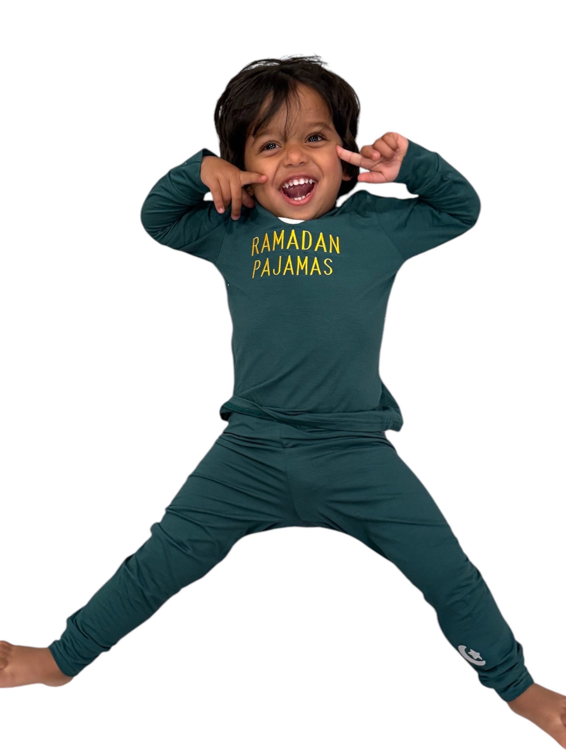 Child wearing green 'Ramadan Pajamas' outfit on a white background