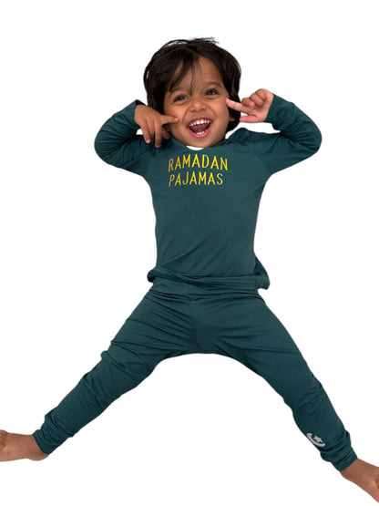 Child wearing green 'Ramadan Pajamas' outfit on a white background