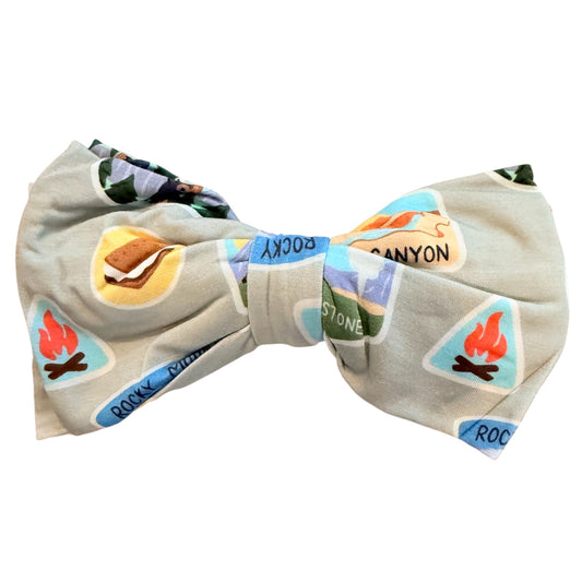 Bow tie with nature-themed design on a white background