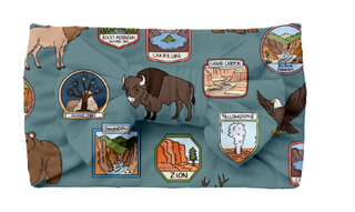 Fleece blanket with nature-themed designs on a blue background