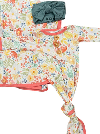 Floral-patterned baby outfit with a green headband on a white background