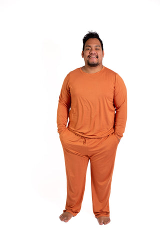 Man wearing a brown pajama set on a white background