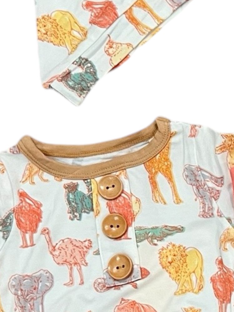 Baby outfit with animal print and brown buttons on a white background