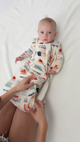 A buttery soft limited edition bamboo sleep sack featuring temperature-regulating fabric, double zippers, neck protection, and cozy Chicago-inspired artwork for sensitive babies.